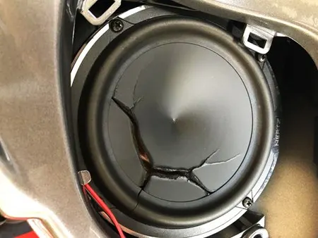 visually inspect for a torn cone on blown out speaker by removing the grill