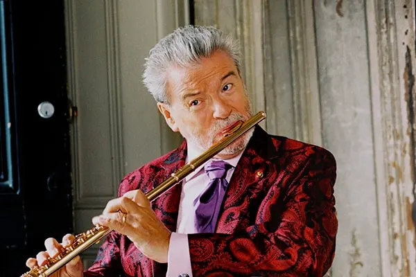 Sir James Galway is our top pick for the best flute players in the world. He's an Irish flutist known for bridging music genres effortlessly.